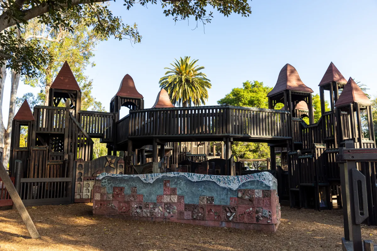Kids' World Playground in Alameda Park, Santa Barbara - children playing on large wooden play structures